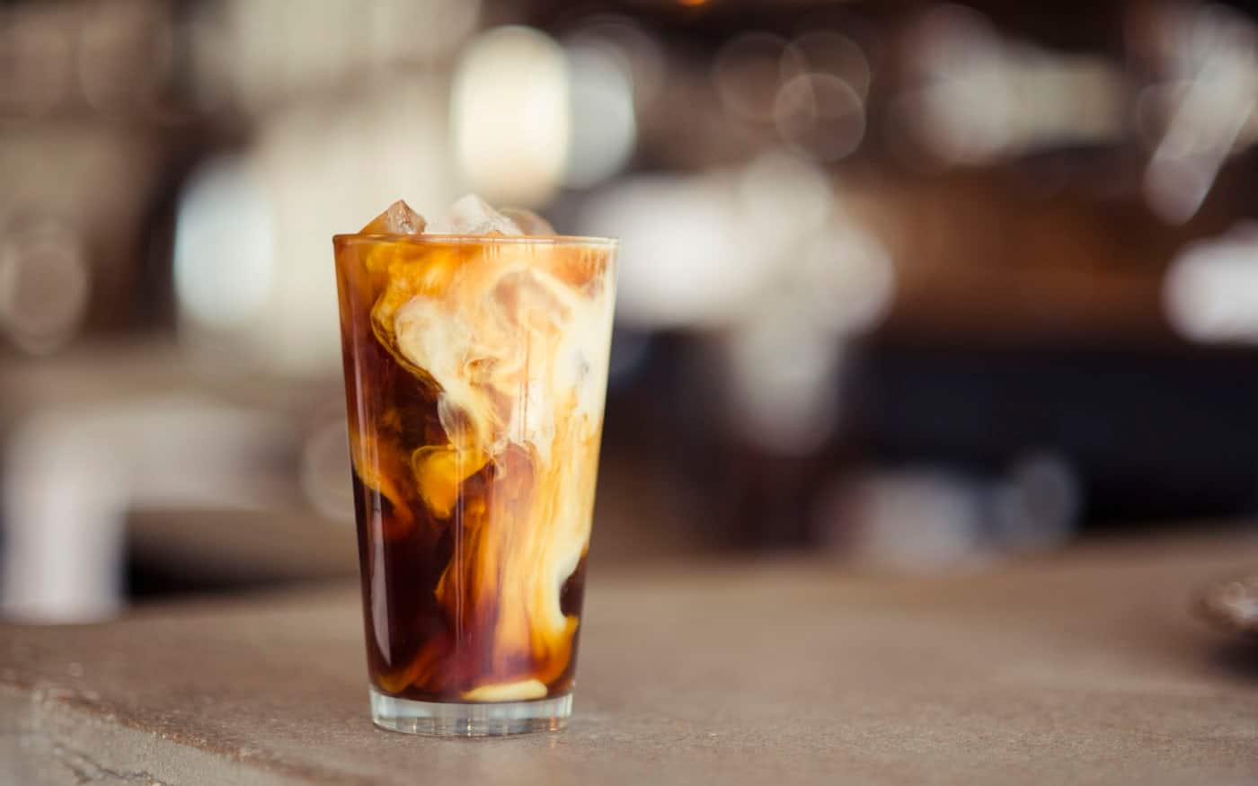 Cold brew coffee being poured over ice at a Brooklyn specialty shop