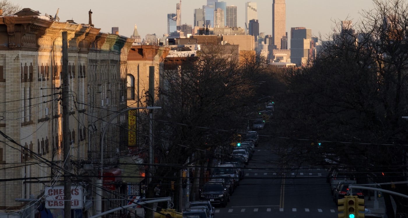Tree-lined street in a Brooklyn neighborhood with brownstone storefronts